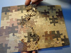 Puzzle² fustellato, intarsiato e intarsiato da Cesare Rocchi